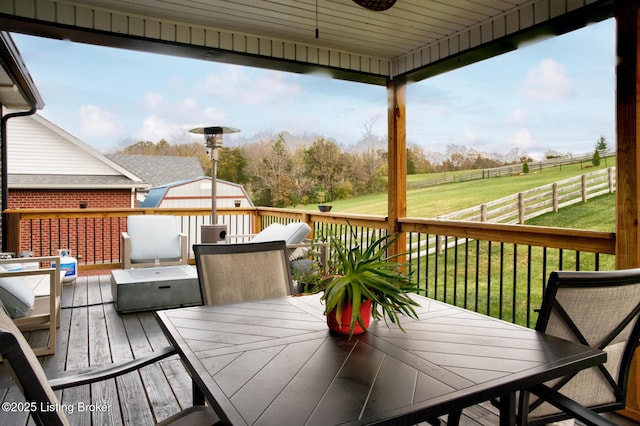 wooden deck featuring a yard and a rural view