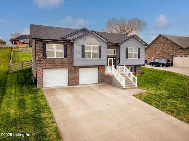 raised ranch with a garage and a front lawn