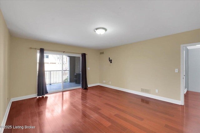 unfurnished room featuring hardwood / wood-style flooring