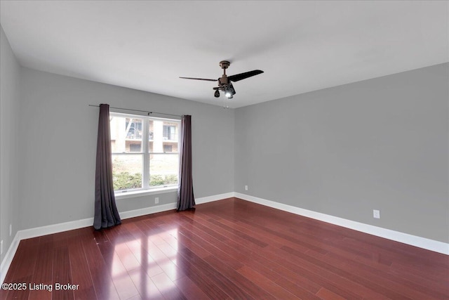 spare room with ceiling fan and dark hardwood / wood-style flooring