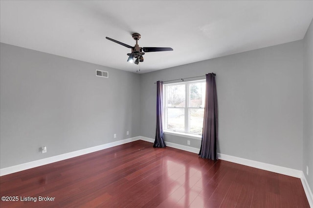 spare room featuring dark hardwood / wood-style floors and ceiling fan