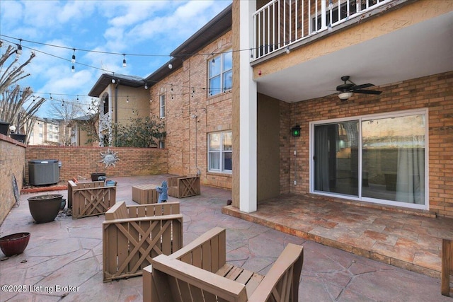 view of patio with ceiling fan and central air condition unit