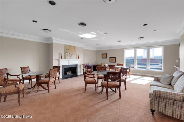 carpeted dining area with ornamental molding