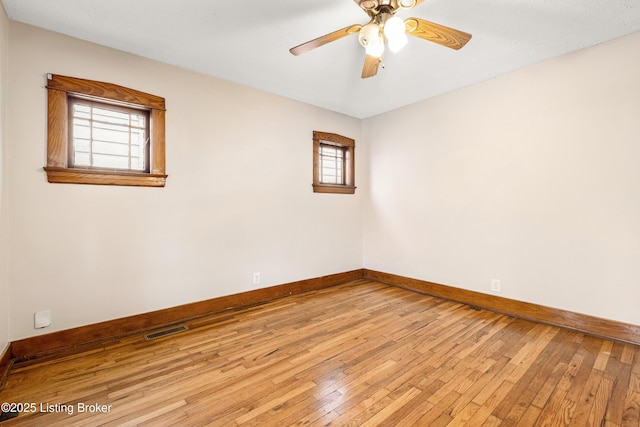 unfurnished room with ceiling fan and light wood-type flooring