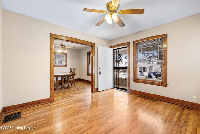 entryway with ceiling fan, light hardwood / wood-style floors, and a textured ceiling