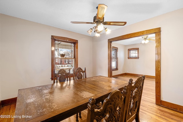 dining space featuring ceiling fan and light wood-type flooring