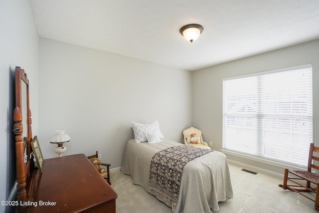 bedroom with light colored carpet