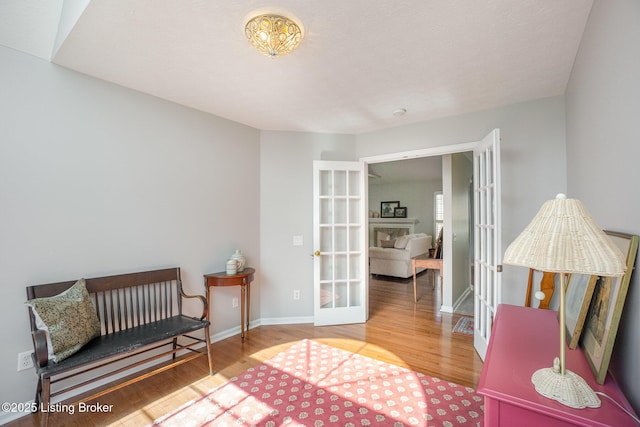 sitting room featuring hardwood / wood-style flooring and french doors