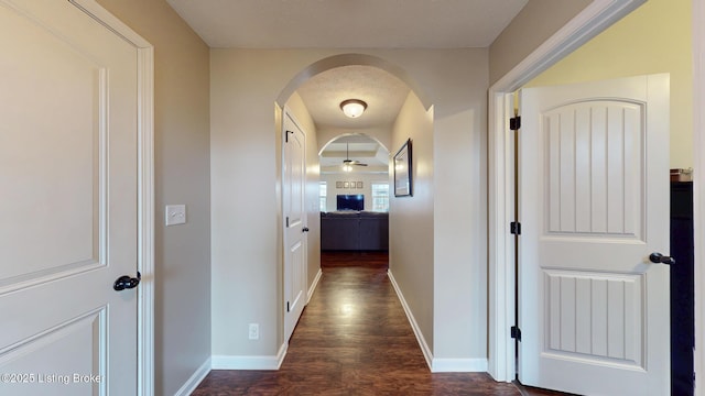 corridor featuring dark hardwood / wood-style floors and a textured ceiling