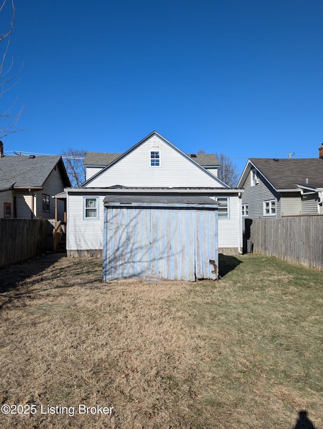 rear view of property with a lawn