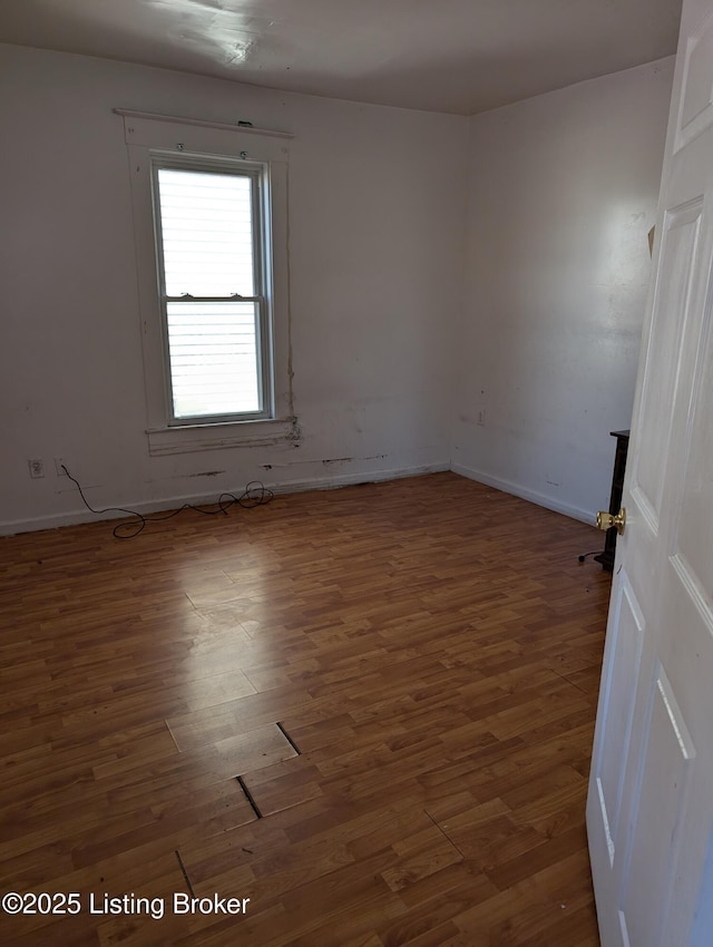 spare room featuring dark hardwood / wood-style floors