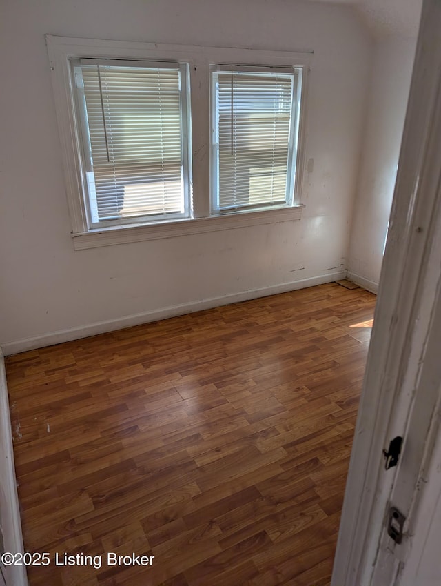 spare room featuring dark wood-type flooring