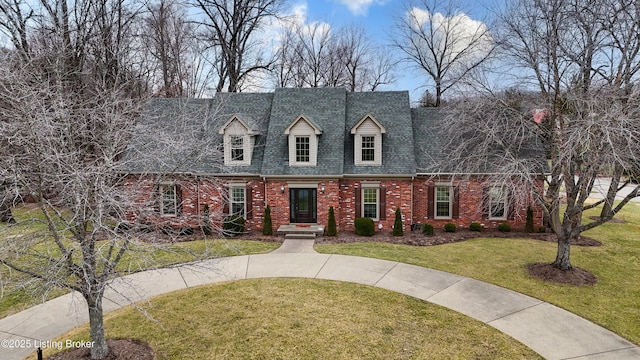 cape cod home with a front lawn