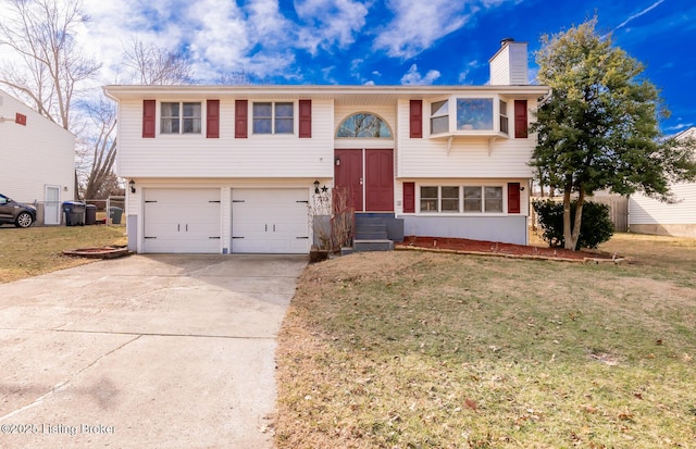 bi-level home with a garage and a front lawn