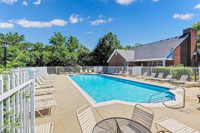 community pool featuring a patio area and fence