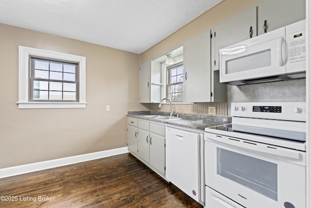 kitchen with sink, a textured ceiling, dark hardwood / wood-style flooring, white appliances, and white cabinets