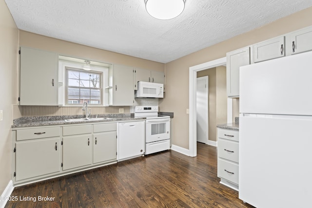 kitchen with sink, white appliances, dark wood-type flooring, a textured ceiling, and white cabinets