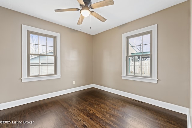 unfurnished room with dark wood-type flooring, a wealth of natural light, and ceiling fan