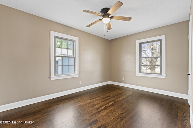 spare room with ceiling fan and dark hardwood / wood-style floors