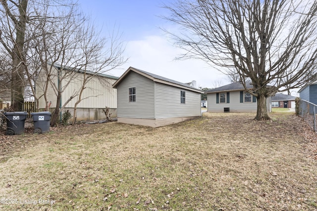 rear view of house featuring a yard