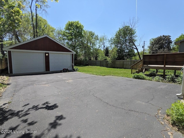 detached garage featuring fence
