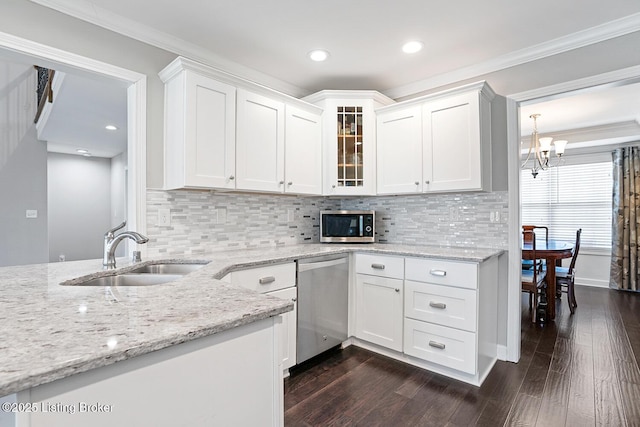 kitchen featuring appliances with stainless steel finishes, dark hardwood / wood-style flooring, sink, and white cabinets