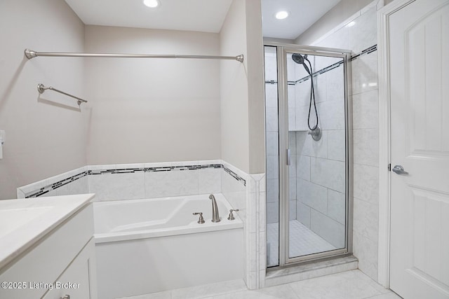 bathroom featuring vanity and independent shower and bath