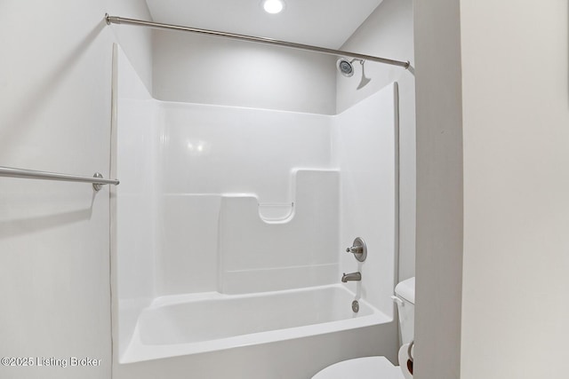 bathroom with washtub / shower combination and toilet