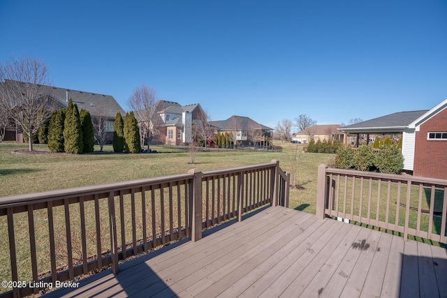 wooden terrace featuring a yard