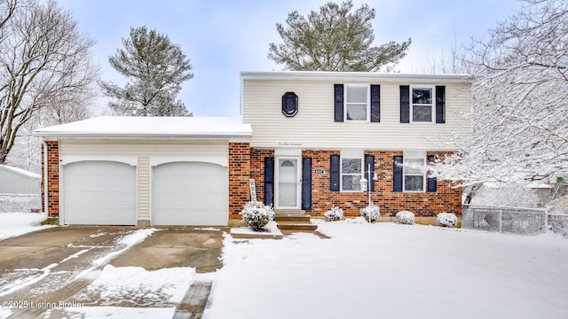 view of front of property with a garage and brick siding