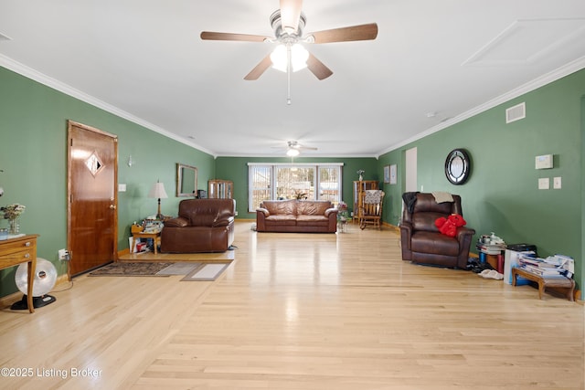 living room featuring ornamental molding, ceiling fan, and light hardwood / wood-style flooring