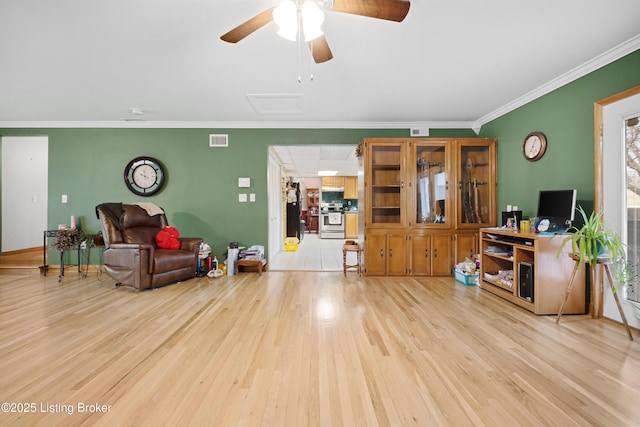 living room featuring ceiling fan, light wood-type flooring, and crown molding