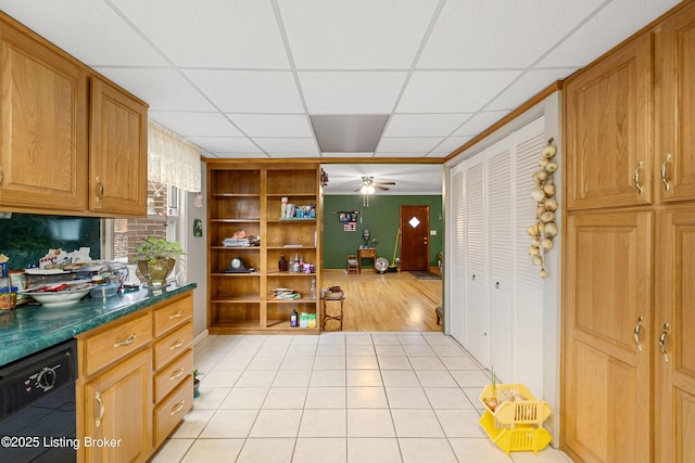 kitchen with ceiling fan, light tile patterned floors, dishwasher, and a drop ceiling