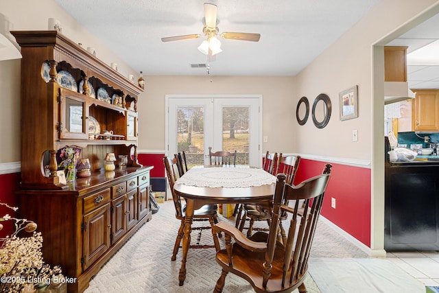 dining room with ceiling fan, light tile patterned floors, and french doors