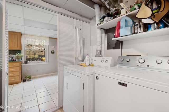 washroom with light tile patterned flooring and washing machine and dryer