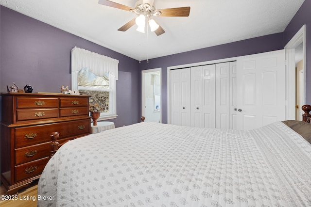 bedroom with a closet, ceiling fan, and wood-type flooring