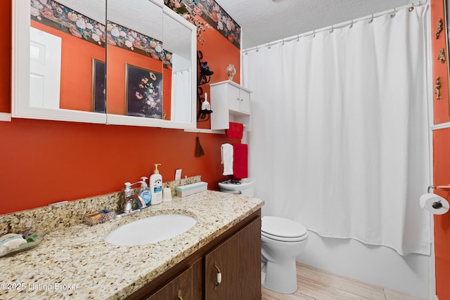 full bathroom featuring hardwood / wood-style floors, vanity, a textured ceiling, shower / bath combo, and toilet