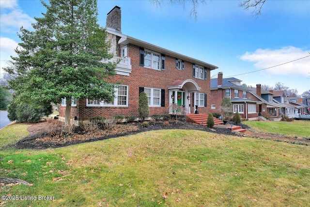 colonial-style house featuring a front lawn