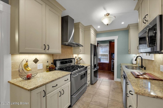 kitchen with sink, stainless steel appliances, wall chimney exhaust hood, and light stone countertops