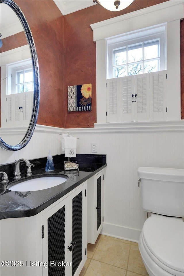 bathroom featuring vanity, tile patterned floors, and toilet