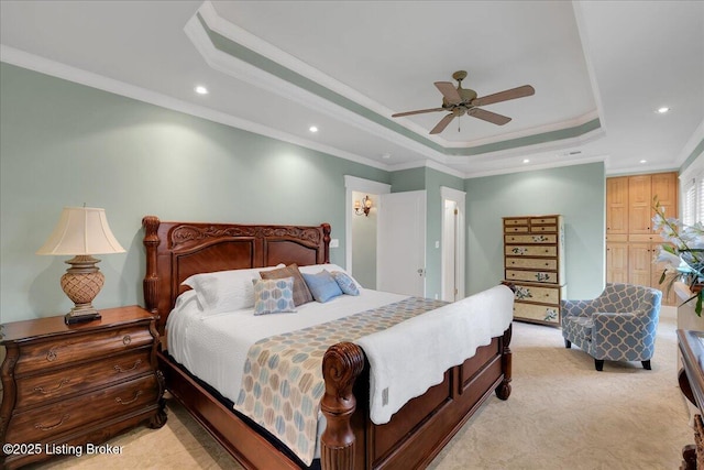 carpeted bedroom featuring crown molding, a raised ceiling, and ceiling fan