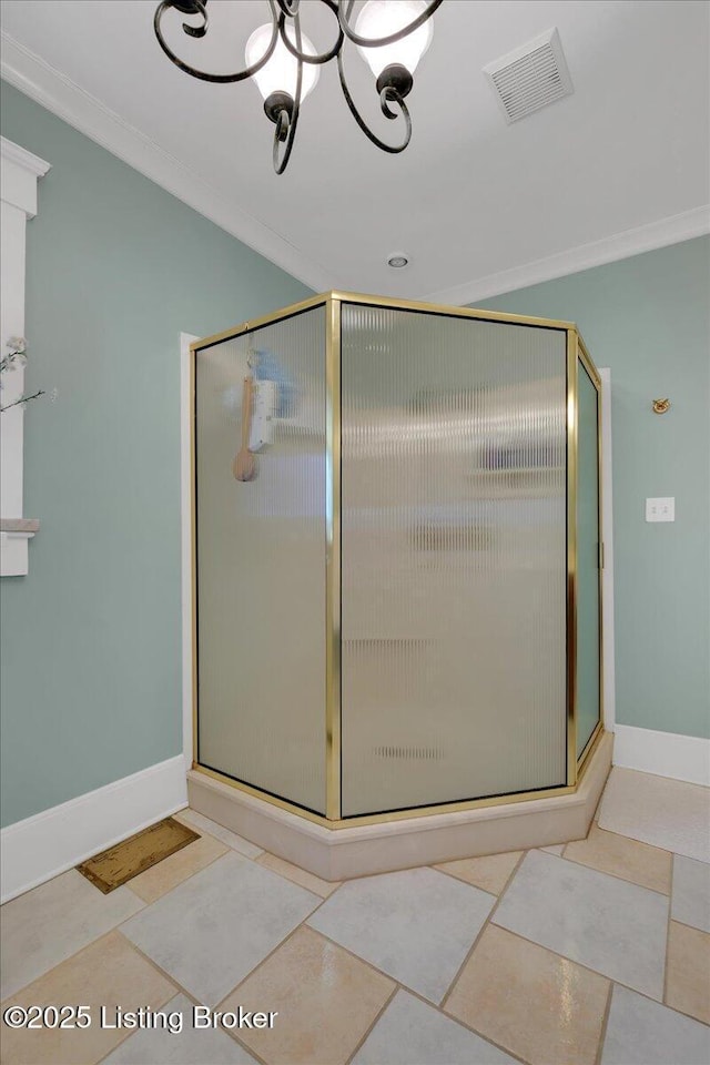 bathroom with an inviting chandelier, tile patterned floors, and ornamental molding