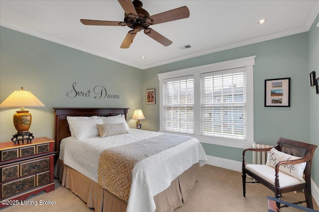 bedroom with ceiling fan, ornamental molding, and light carpet