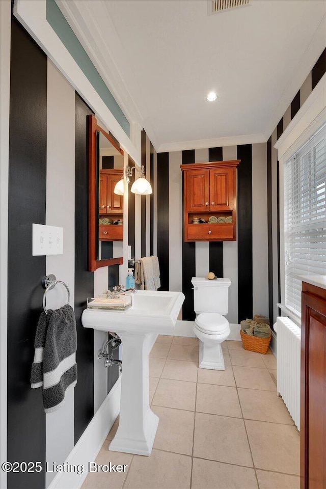 bathroom with radiator heating unit, tile patterned floors, and toilet