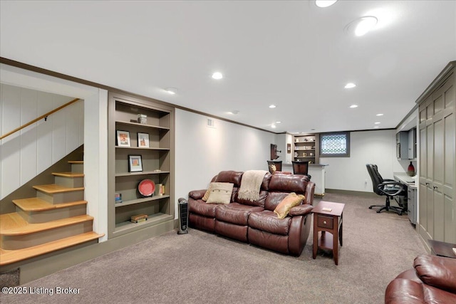 living room with crown molding, carpet, and built in features