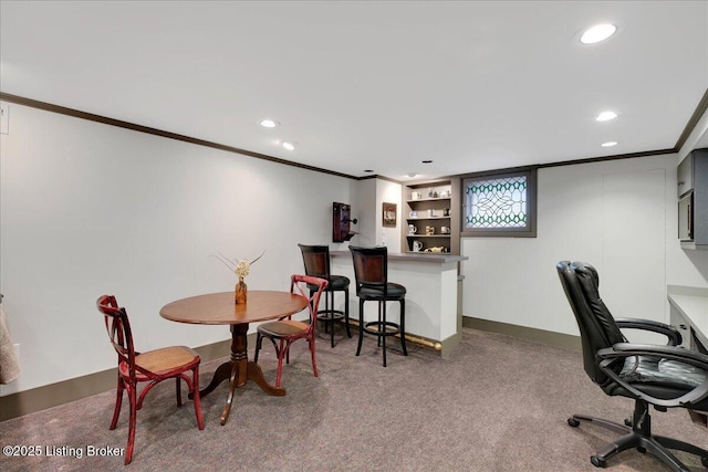 home office featuring dark colored carpet, crown molding, and bar area