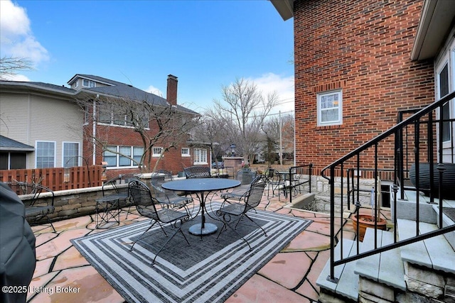 wooden terrace with a patio area