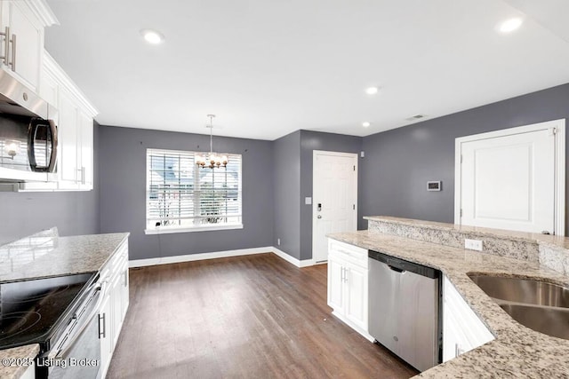 kitchen with light stone counters, white cabinetry, baseboards, appliances with stainless steel finishes, and dark wood-style floors