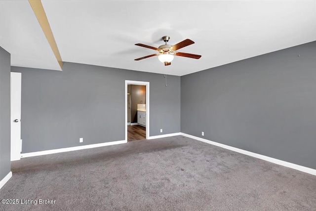 unfurnished room featuring ceiling fan, carpet flooring, and baseboards