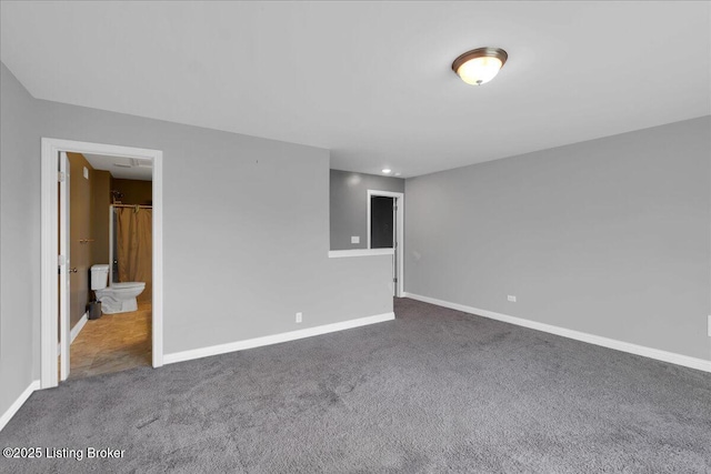 carpeted empty room with baseboards